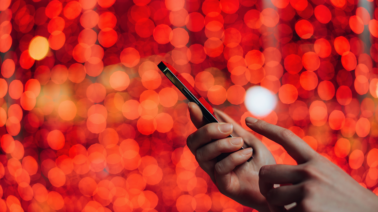 A person holding a cell phone in their hand