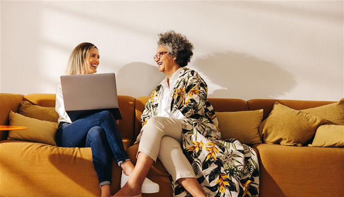 Two women smiling and discussing