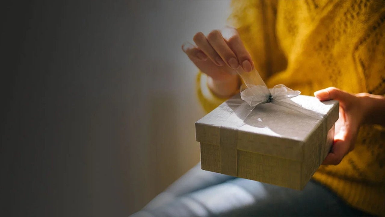 Woman unwrapping gift.
