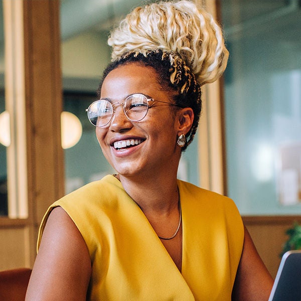 Woman in a yellow shirt smiling