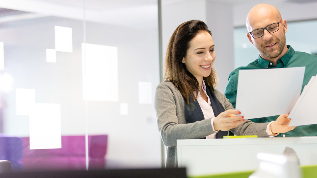 Group of coworkers laughing together in the office