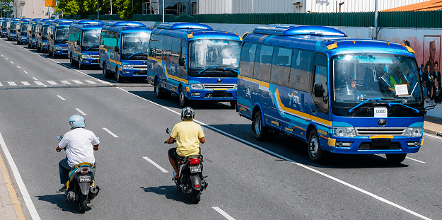 Motorcyclists and buses on a road