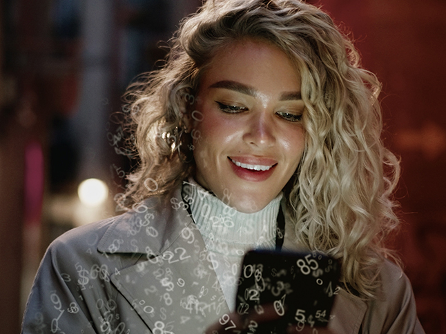 Woman looking at phone outside restaurant