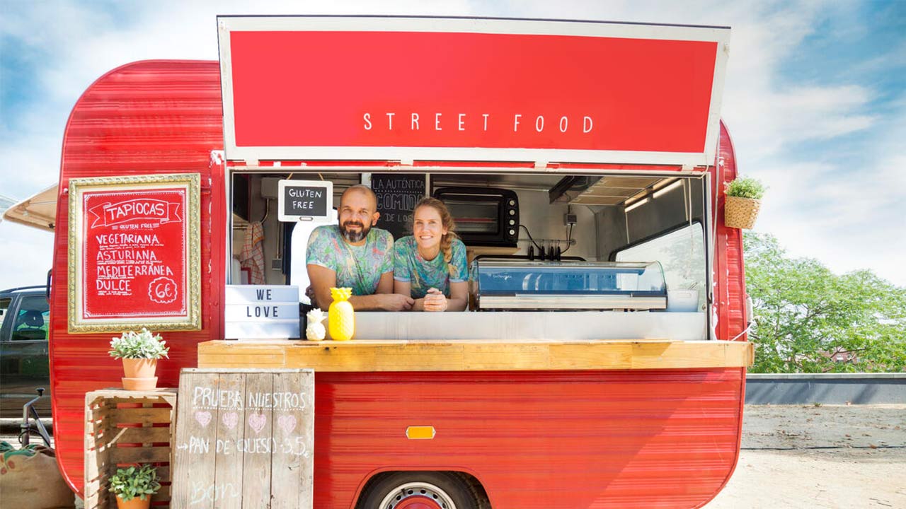 Red food truck and owners.
