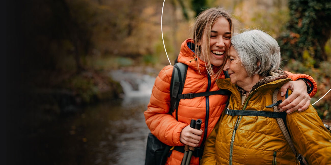Two smiling people enjoying the benefits of being a Mastercard cardholder.