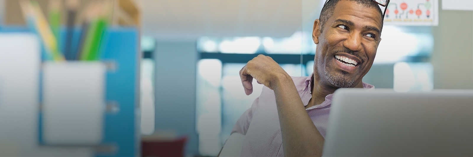 Two people smiling on a street.