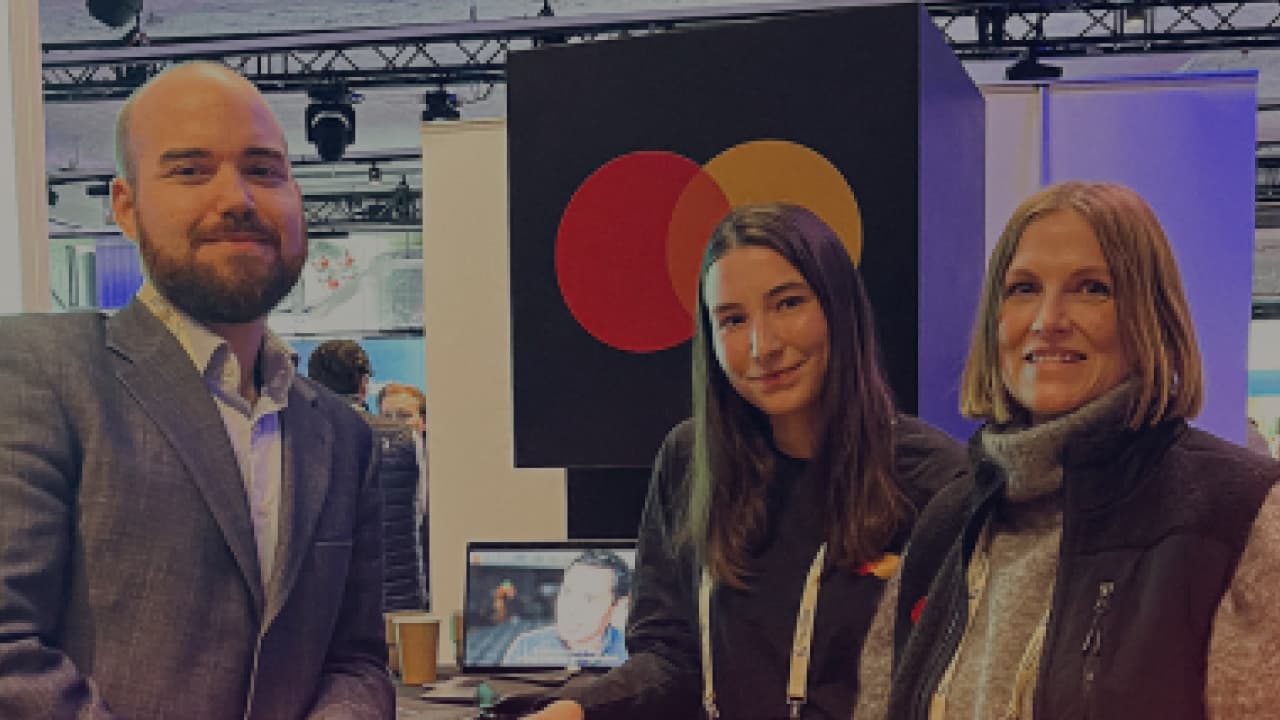 three people mastercard booth photo 2025