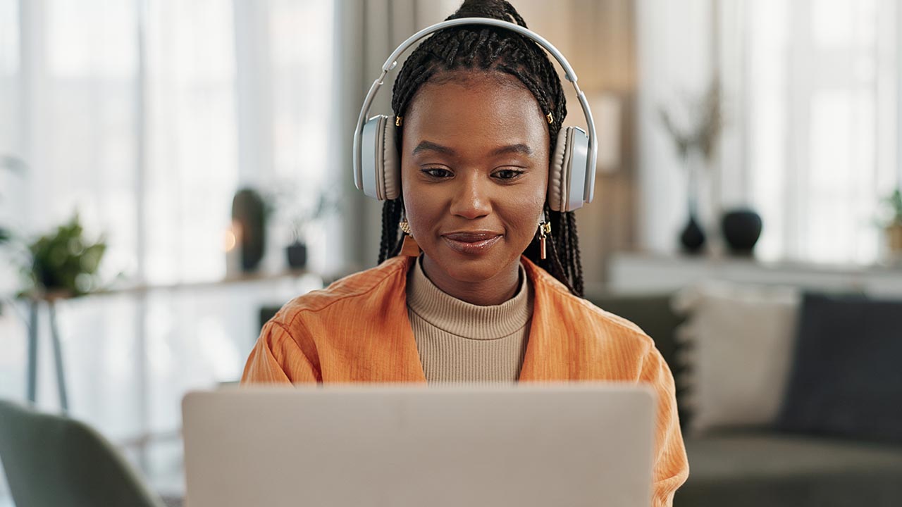 Woman watching training session on laptop.