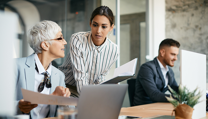 Two women coworkers brainstorming