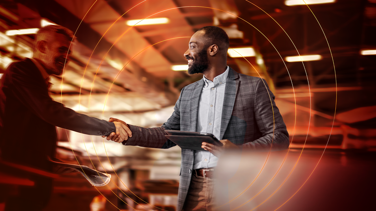 Two men shaking hands in the office