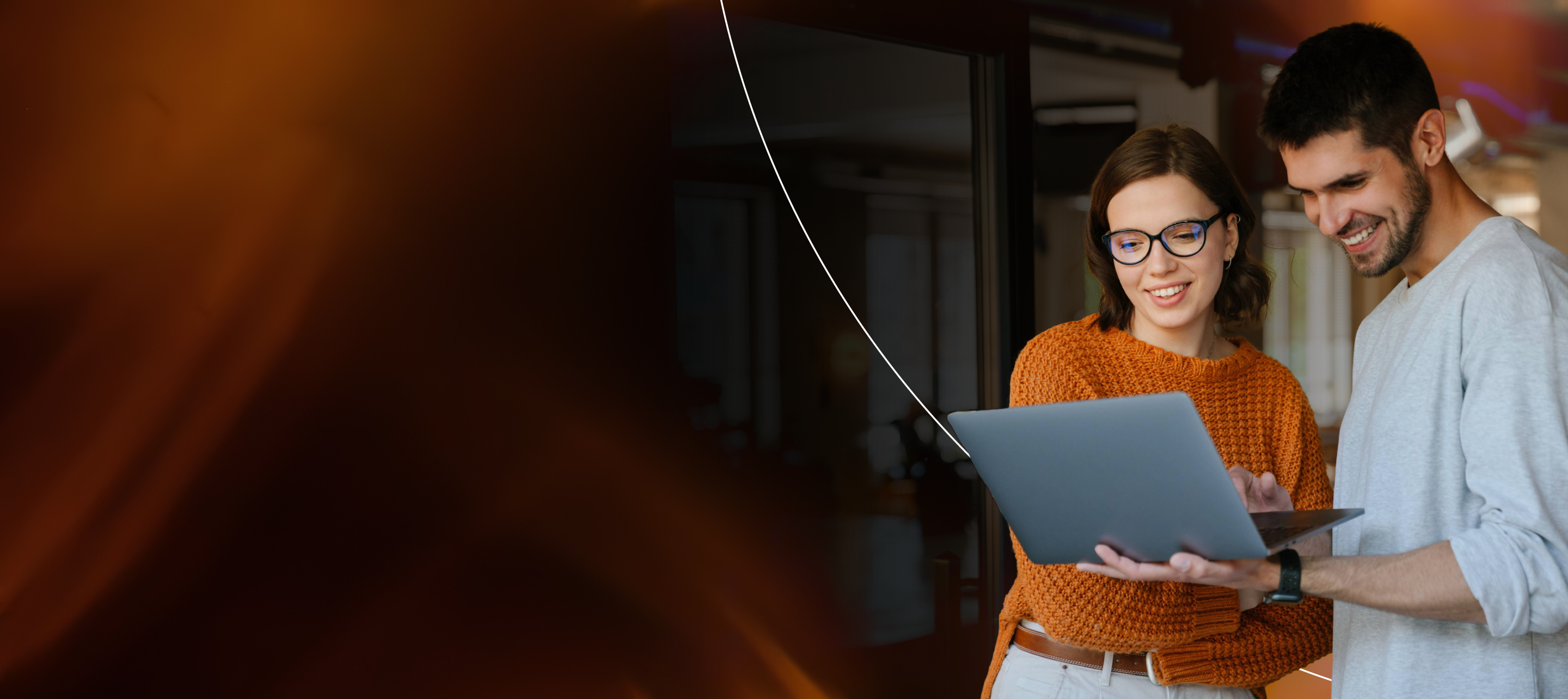 Man and woman reviewing market insights on a laptop