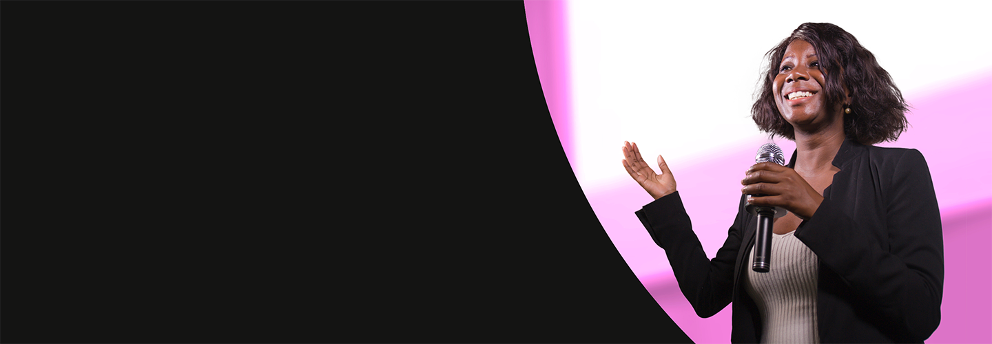 Woman speaking in front of a screen