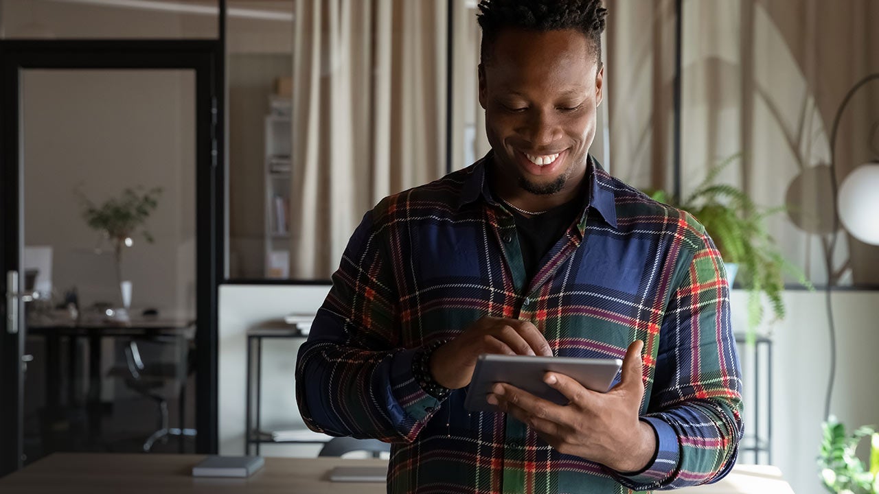 Self-employed professional using a tablet in an office.