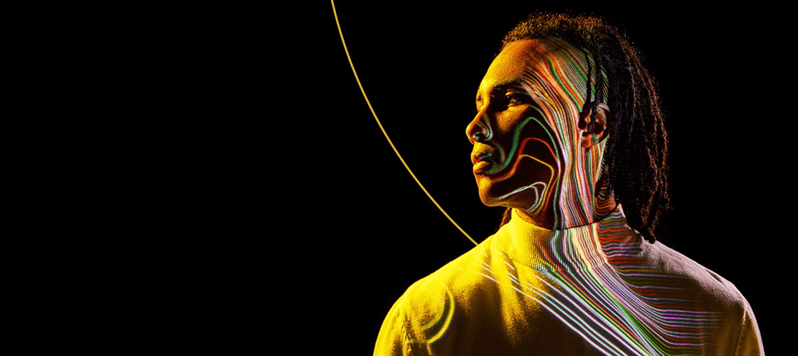 Man looking into distance under colored lighting