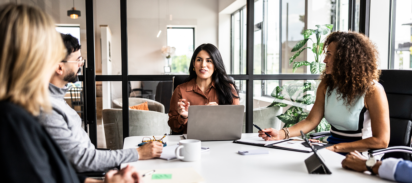 Group of coworkers in the obvious discussing insights