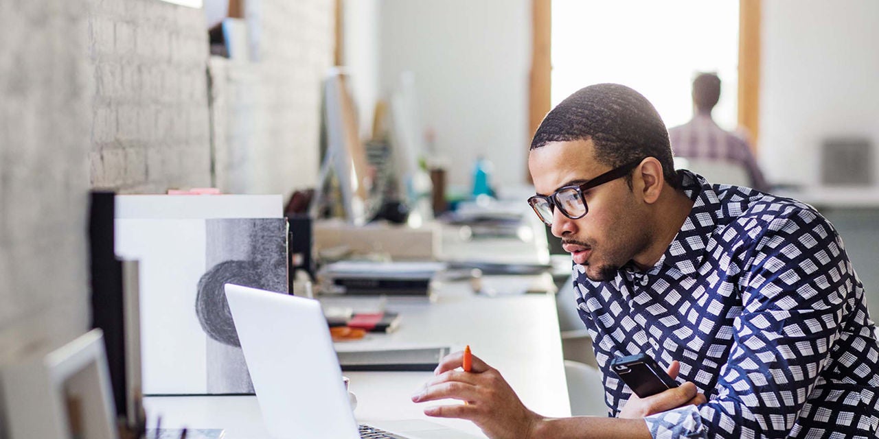 Man with glasses using a computer