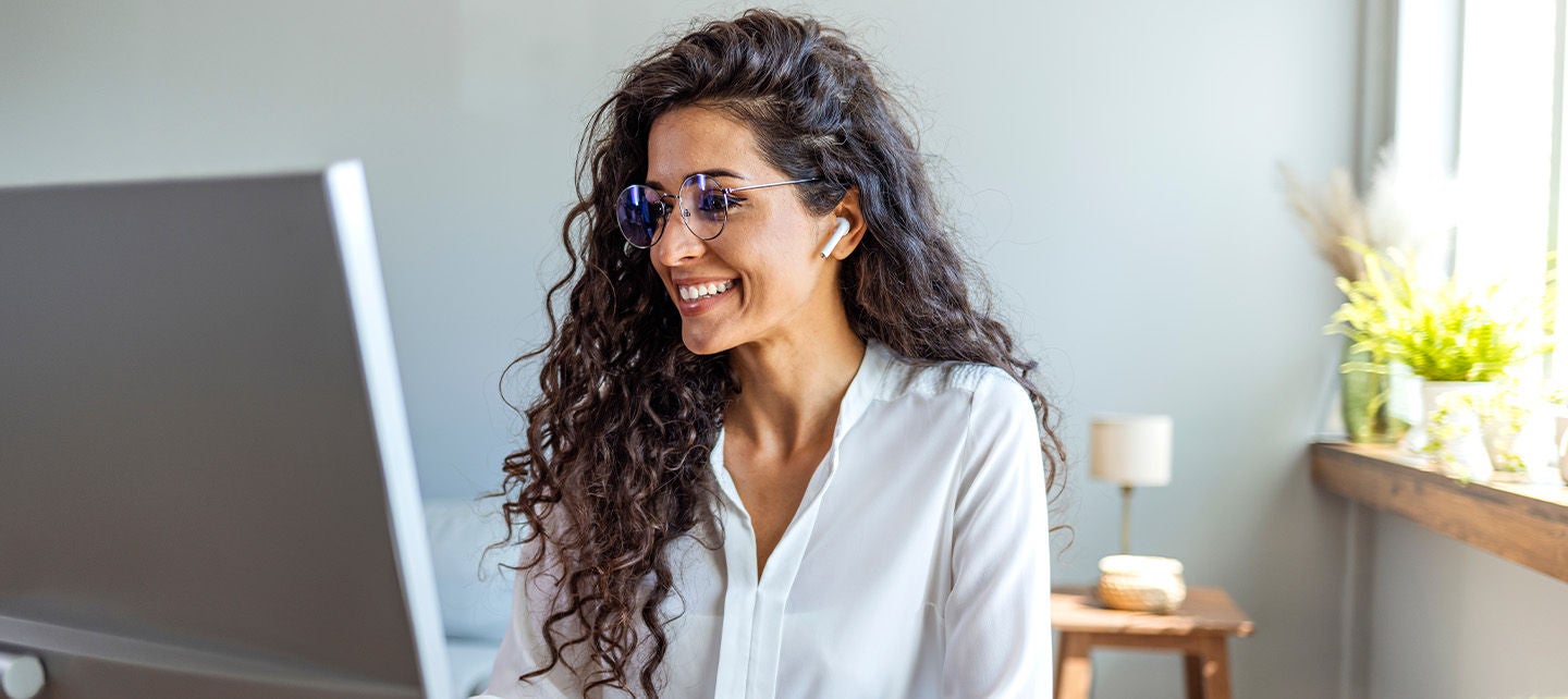 Woman with glasses working on her computer