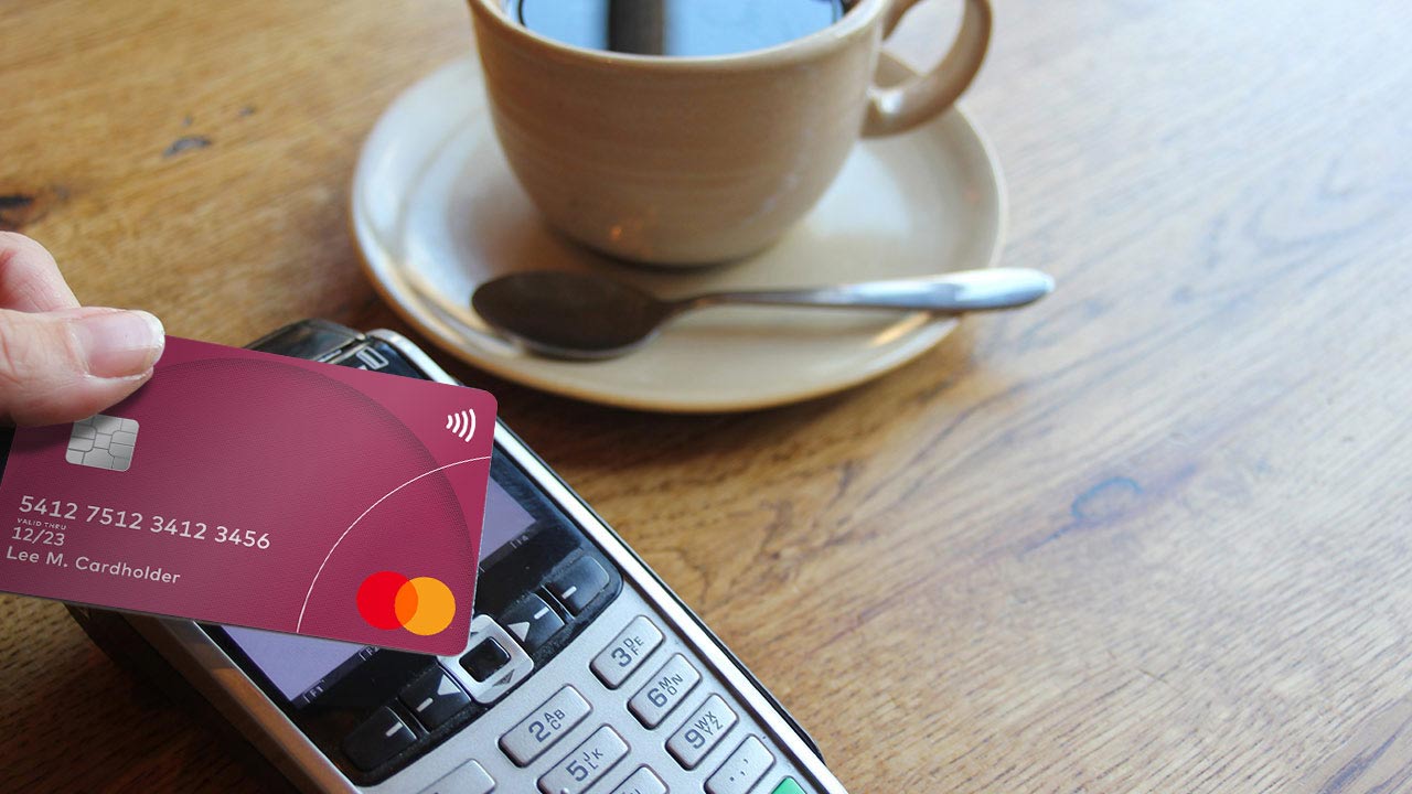 Close up shot of tapping with a card on a payment terminal at a cafe