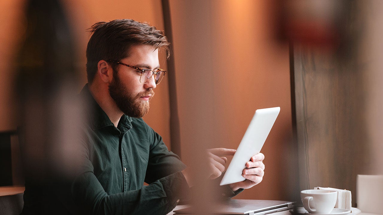 man focused on tablet.