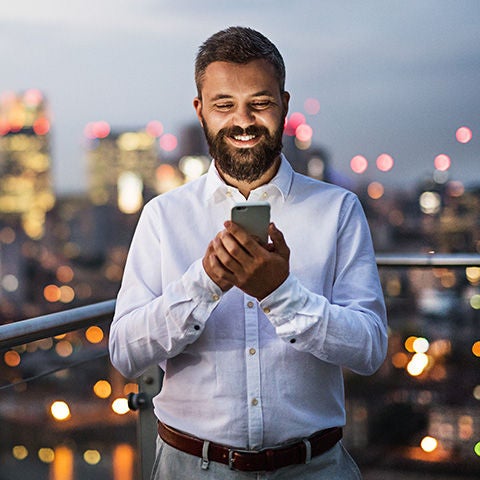 Woman smiling holding phone