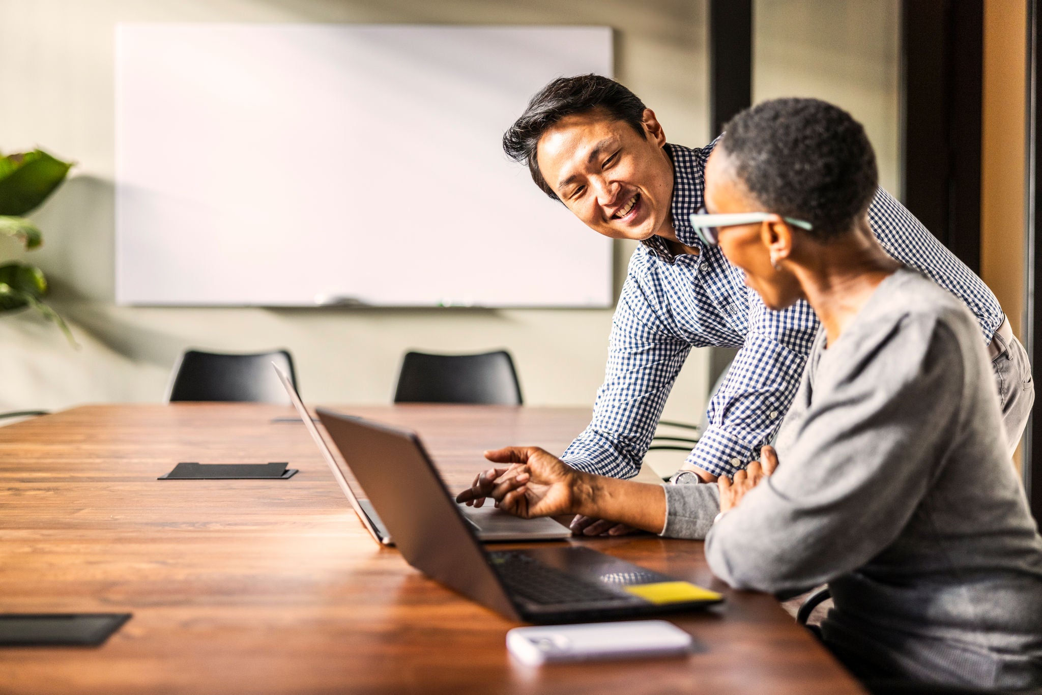Two people in a conference room discussing Money Movement