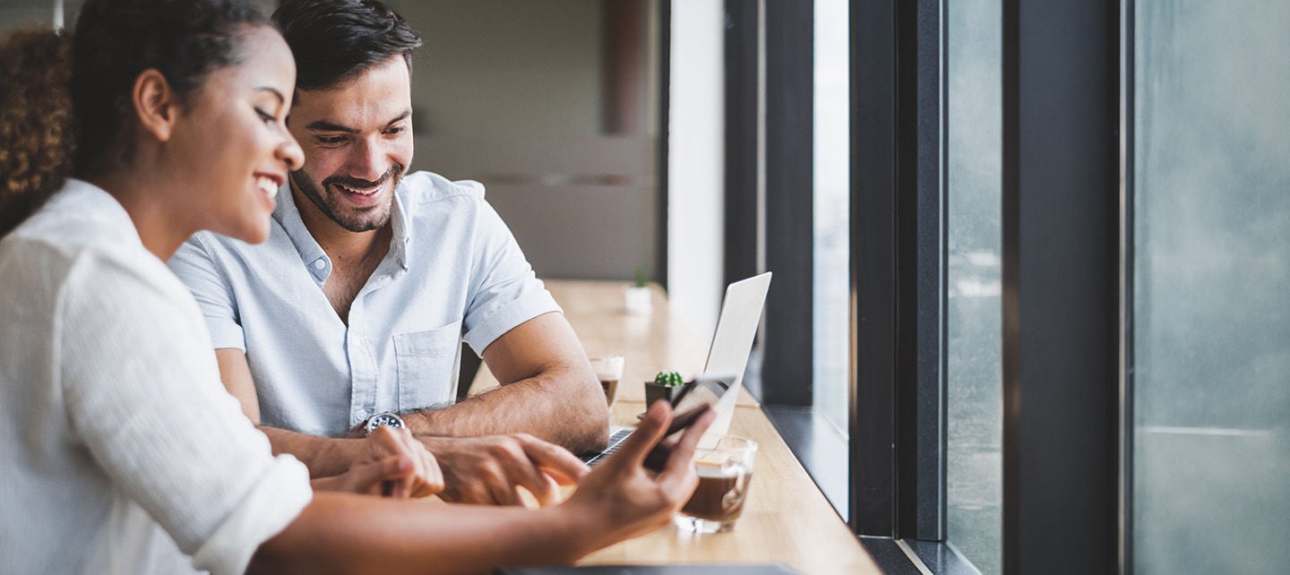 Woman and man looking ath smartphone