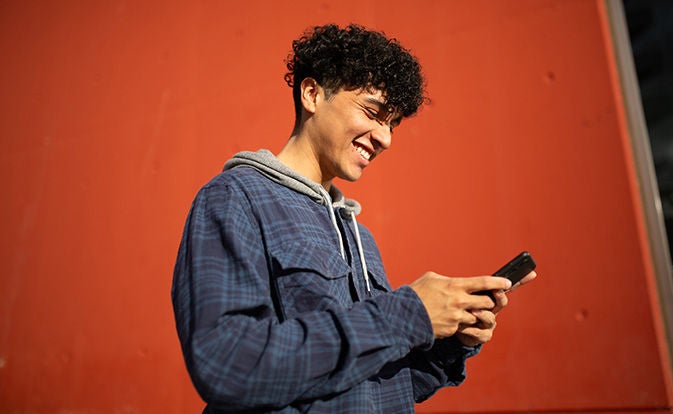 Engaged young customer using phone.