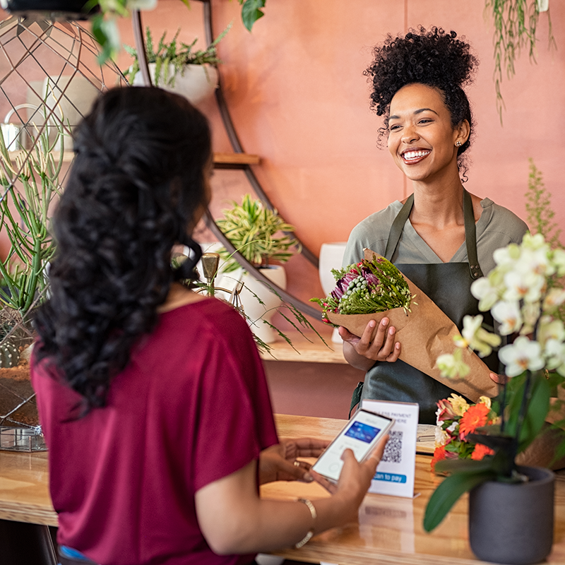 Woman selling personalized flowers to a customer