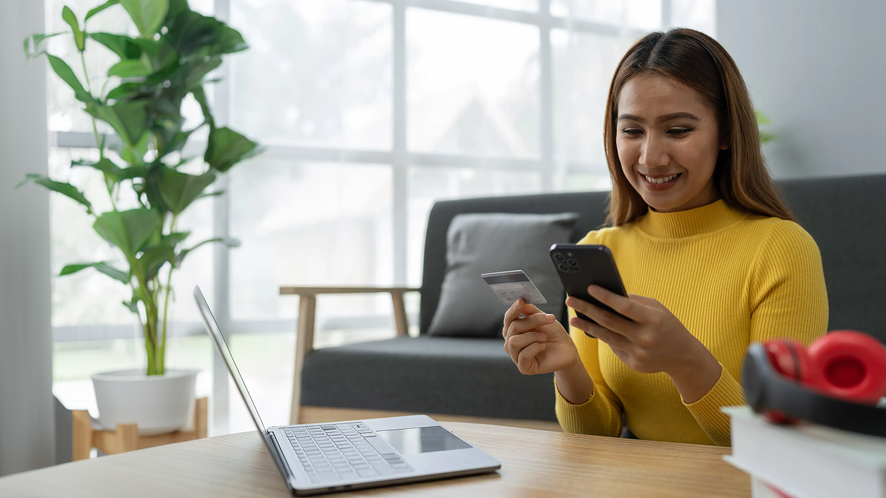 Woman wearing yellow top using her phone