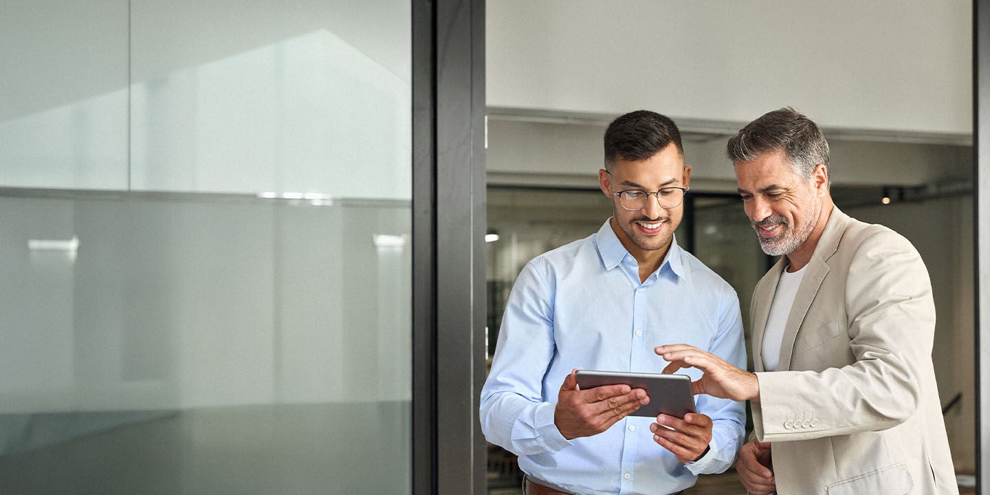Two men using a tablet at work
