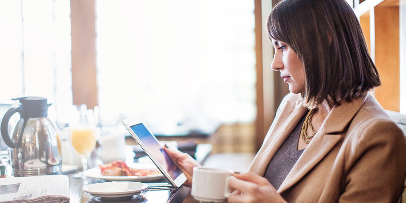 Two people smiling on a street.