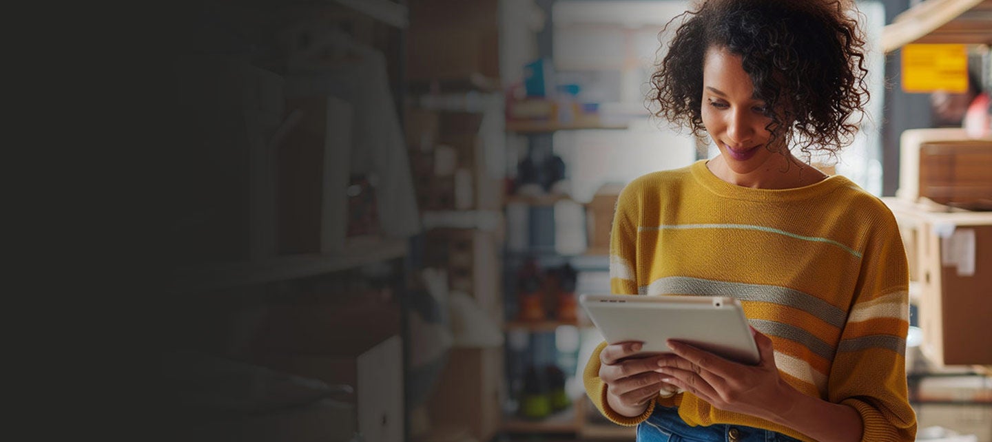 Woan working on a tablet in an office.