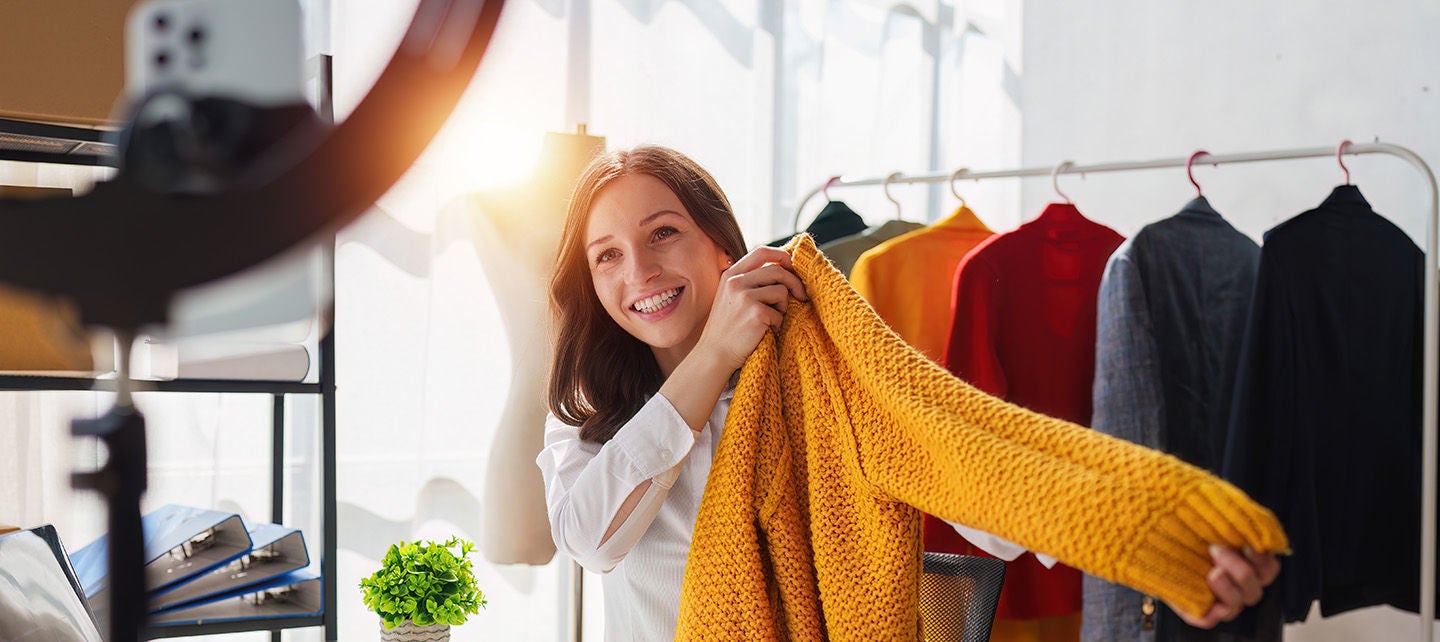 Woman recording a video of a sweater