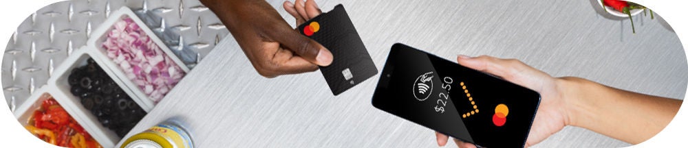 In person payment with card and business phone, consumer payment for a meal.