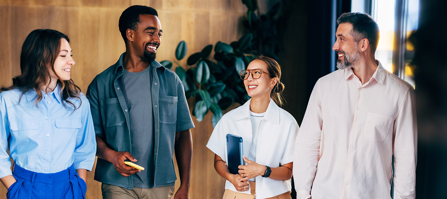 Diverse group of coworkers walking around in the office