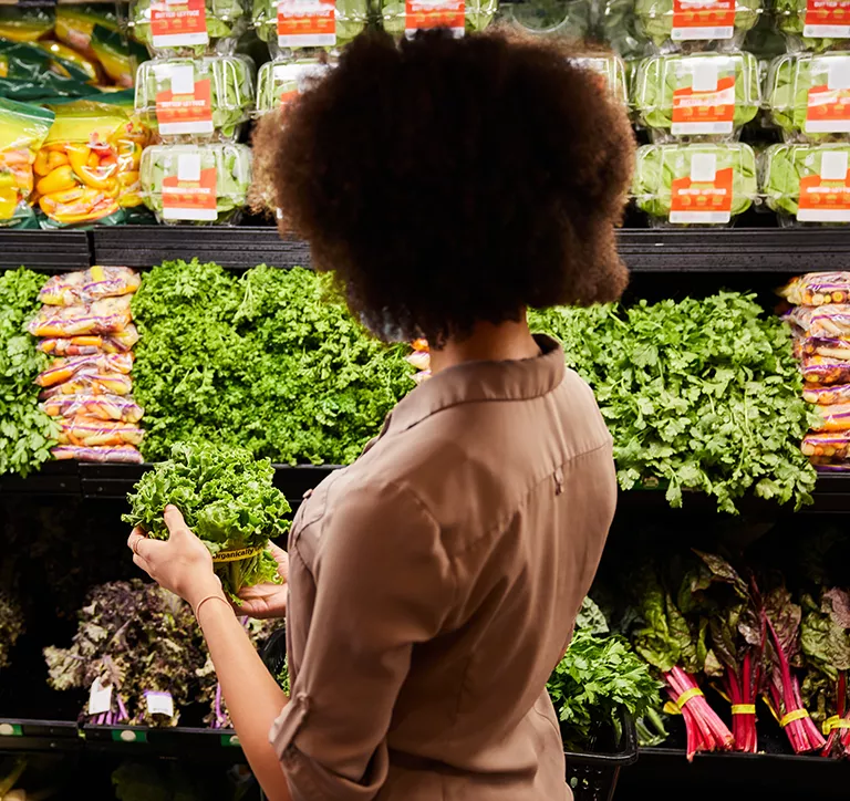 Woman selecting vegetables at a store