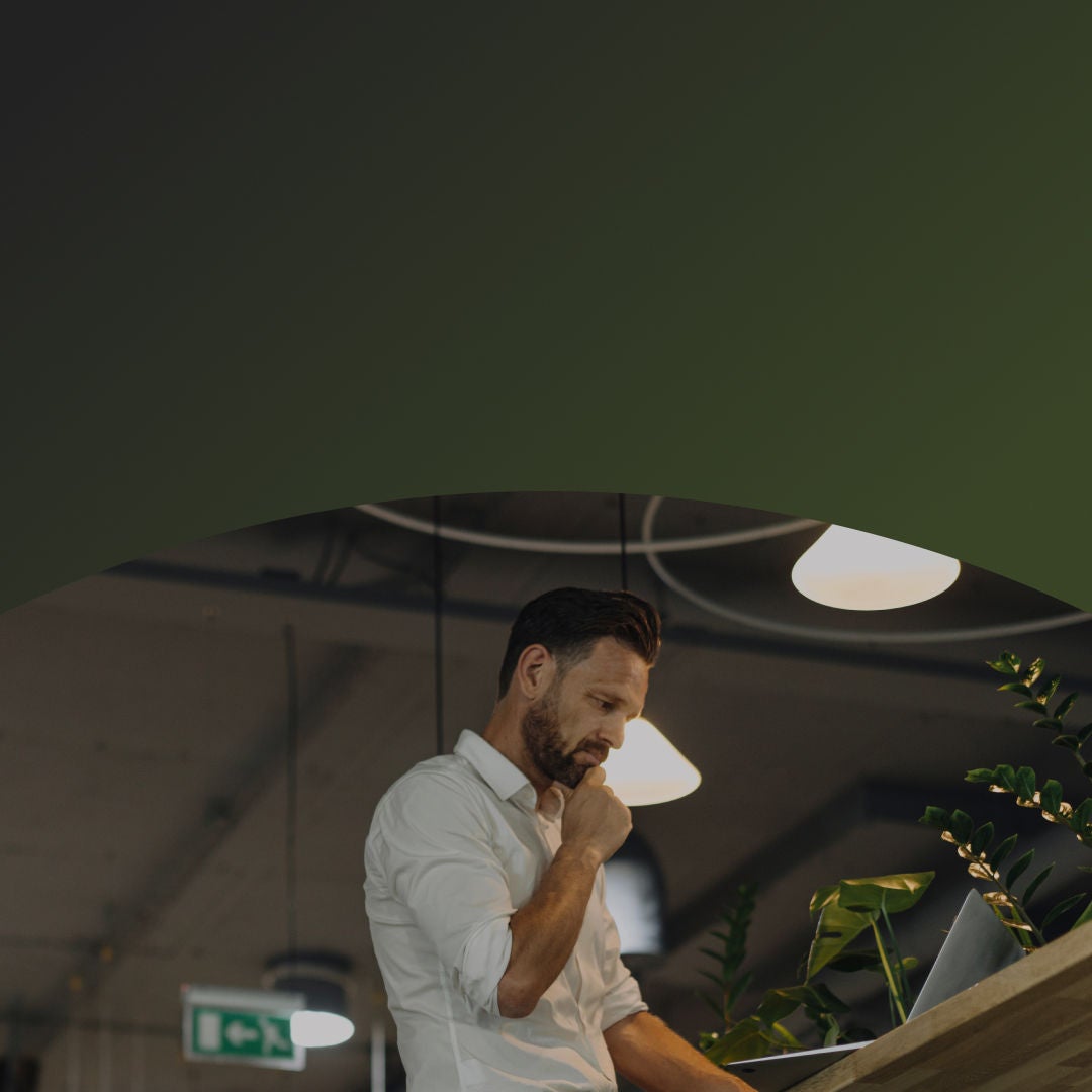 man on a computer with headphones on