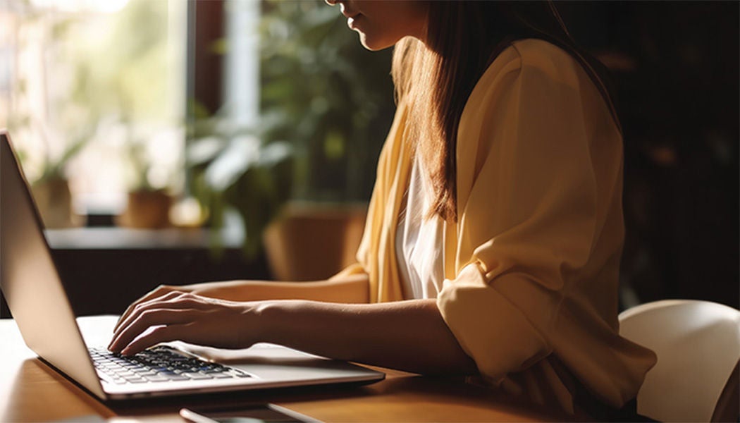 Young woman using laptop at home
