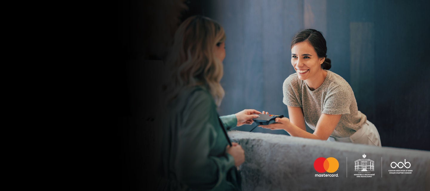 woman looking at clothing rack inside mastercard logo silhouette