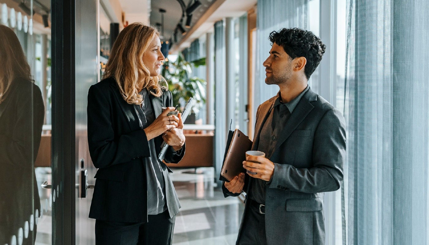 A couple of co-workers discussing the clients they're advising