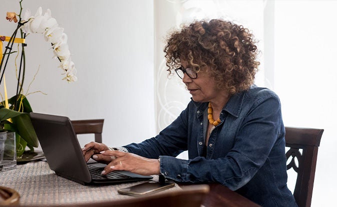 Woman using her latpop at home
