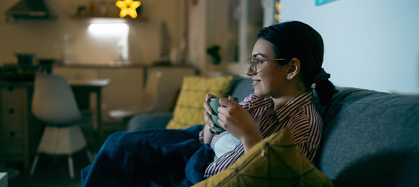 Woman drinking a coffee watching netflix