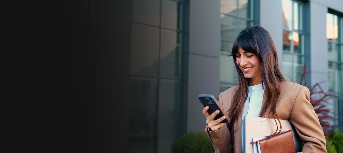 Woman smiling on her phone outside