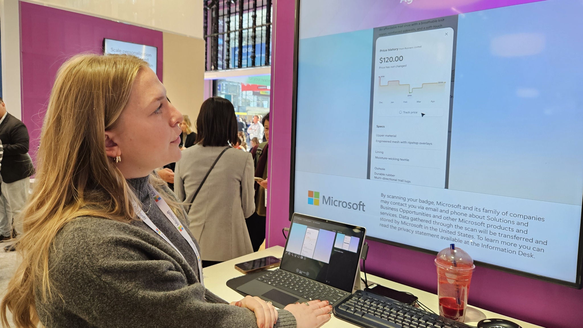 A woman in the Microsoft booth looks at a screen. 