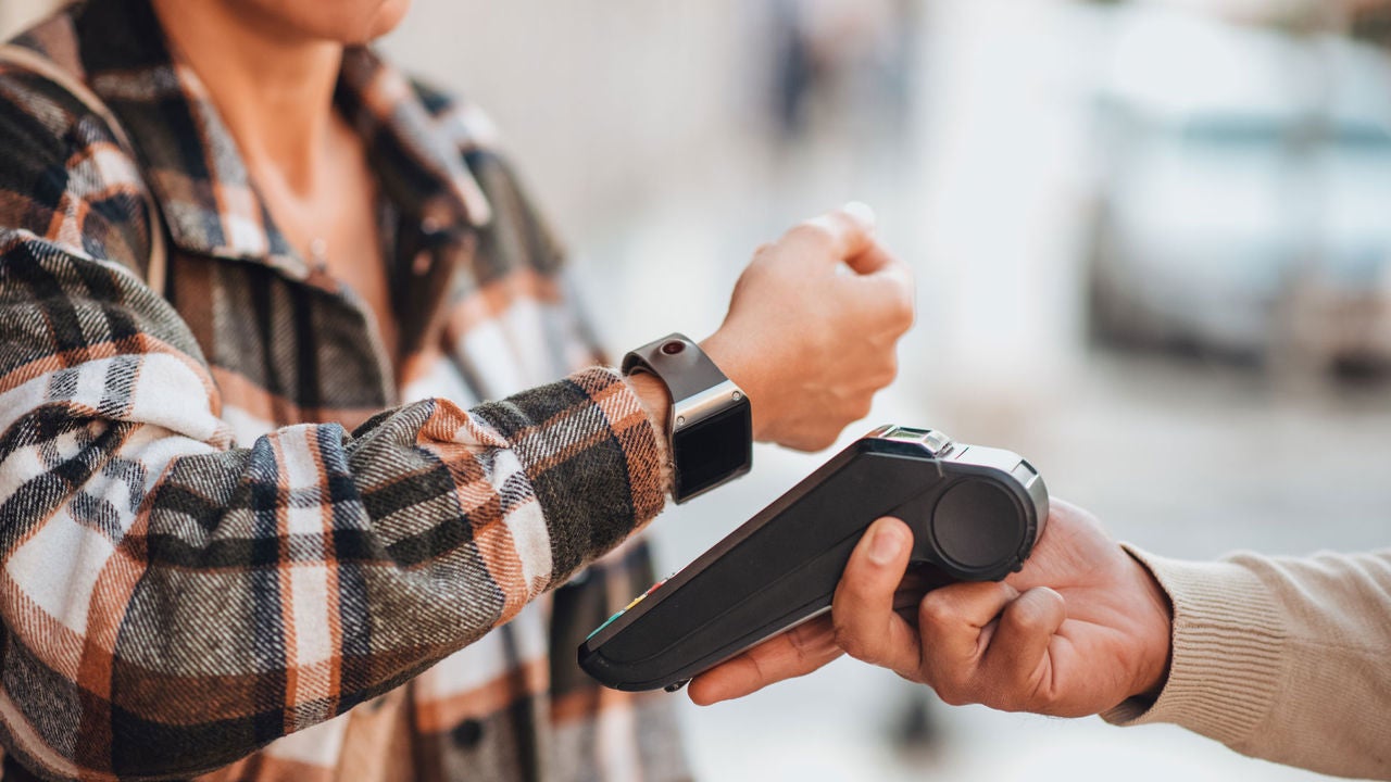 Person paying with their smartwatch