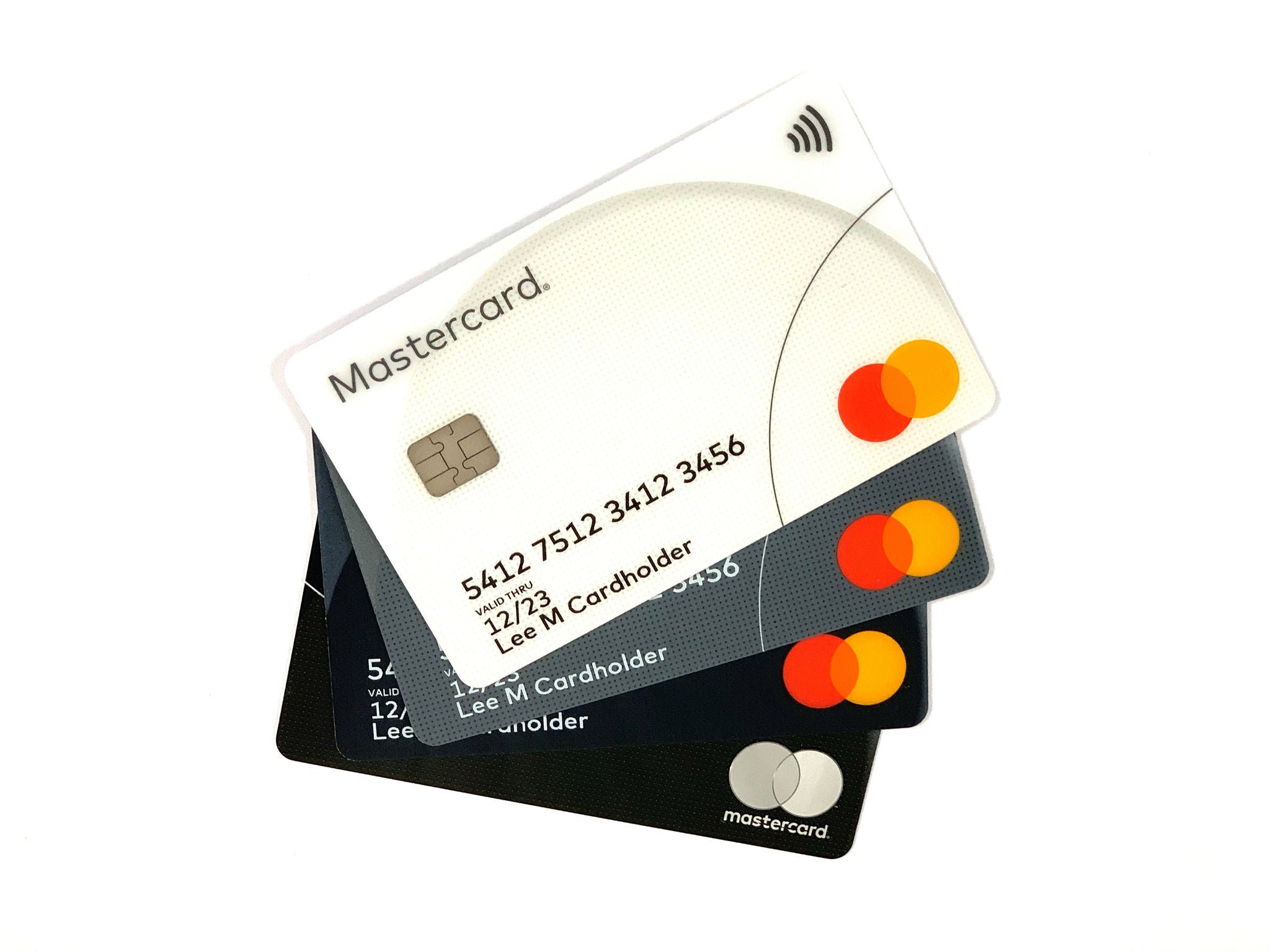 Four payment cards in white, grey, and black fanned out against a white background.