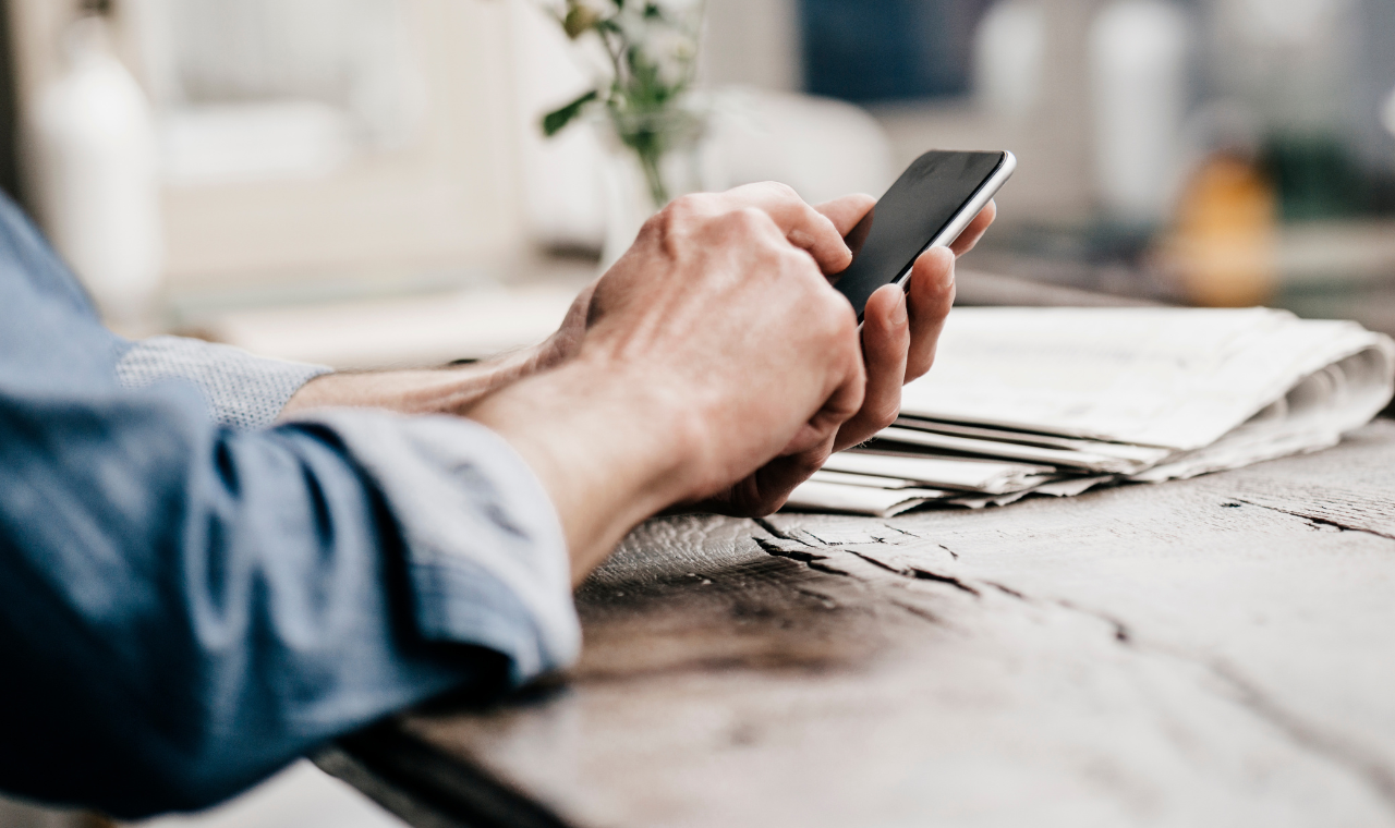 man in cafe using smartphone