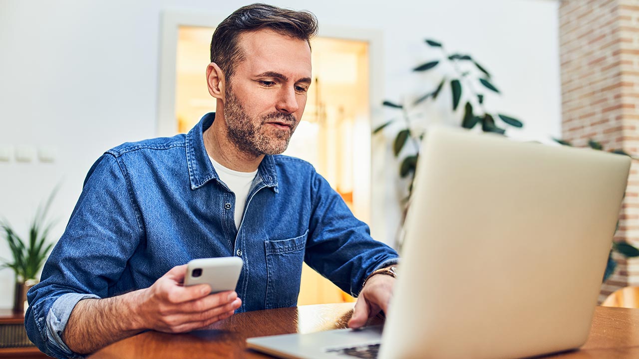 Stressed looking man working in home office.