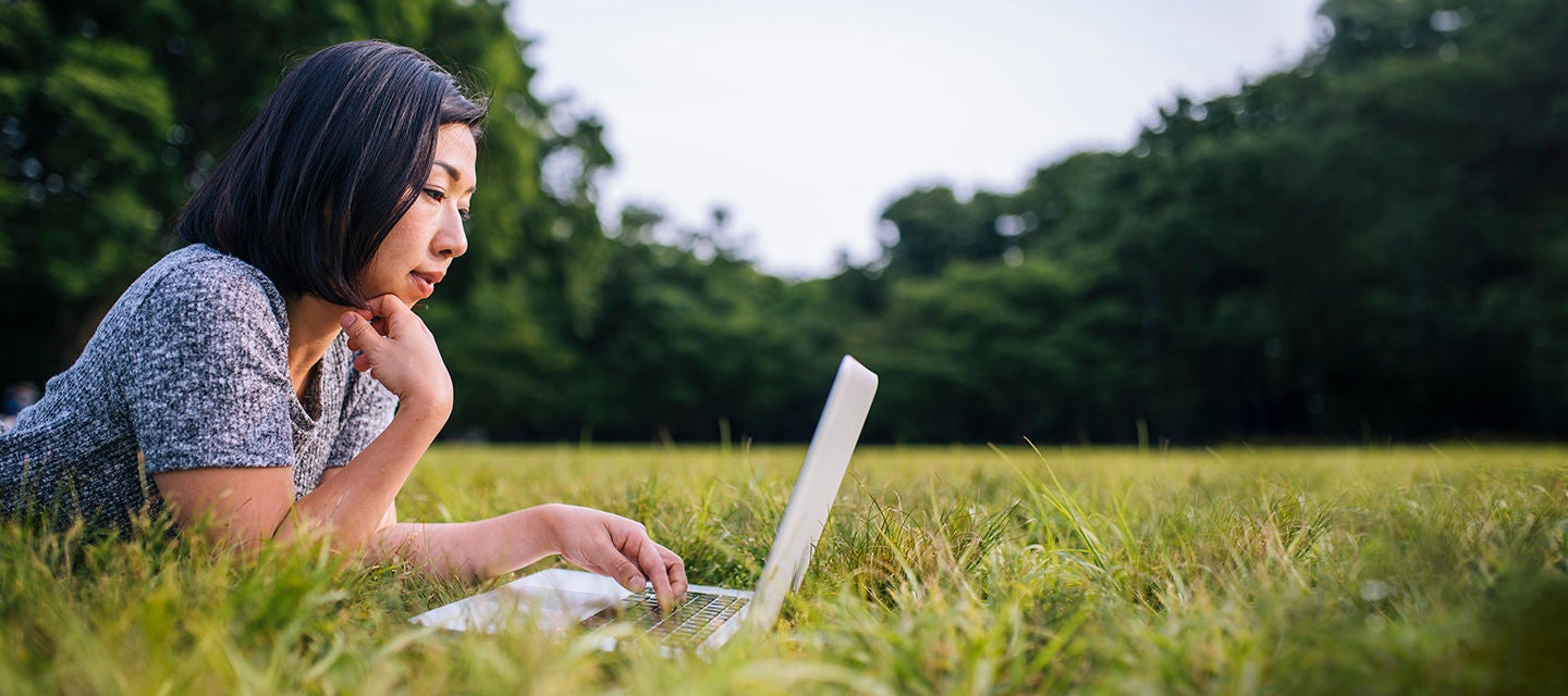 Woman outside on laptop
