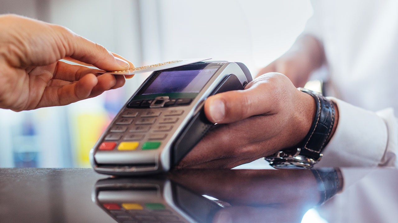 A customer is using NFC technology for payment at a bar.